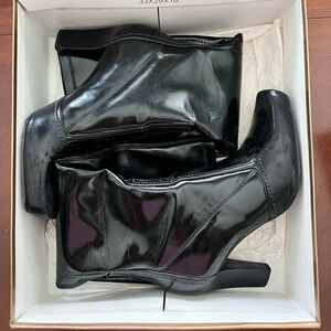 Franco Sarto just below the knees patent boots.